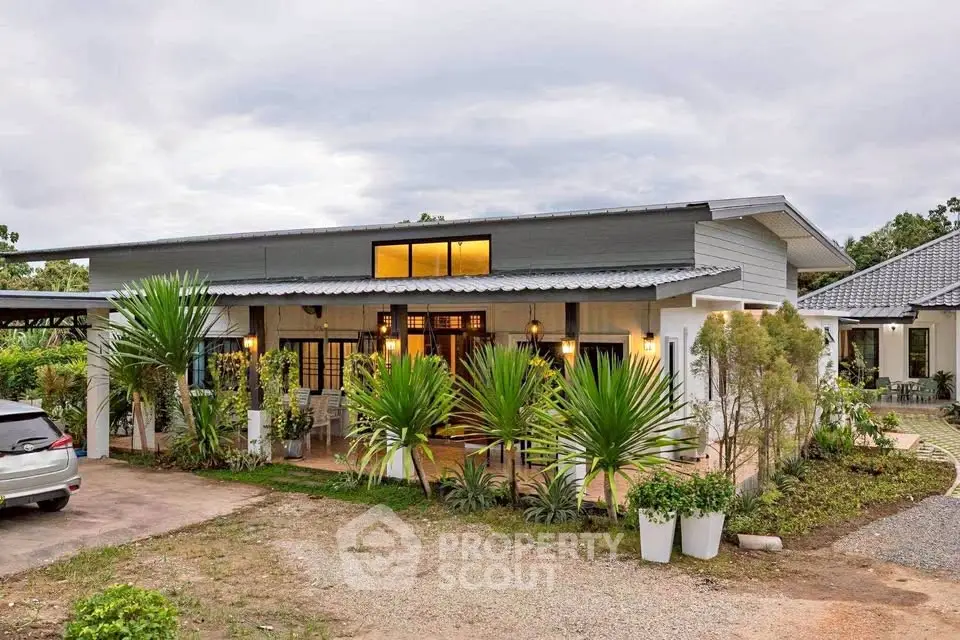 Modern single-story house with lush garden and large windows
