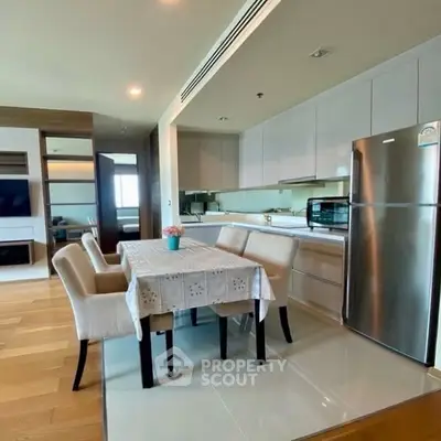 Modern kitchen with dining area and stainless steel appliances in open layout