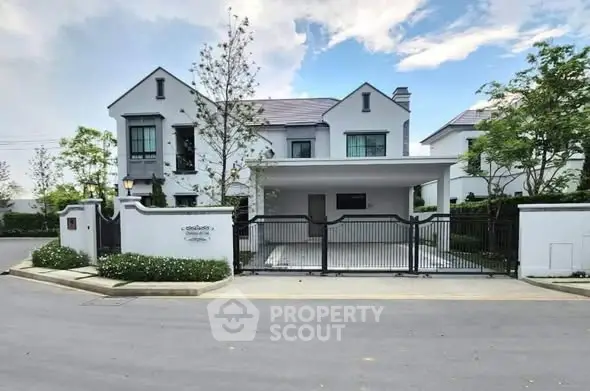 Elegant modern house with spacious driveway and lush greenery in a serene neighborhood.