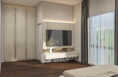 Modern bedroom with large TV, elegant decor, and natural light through sheer curtains.