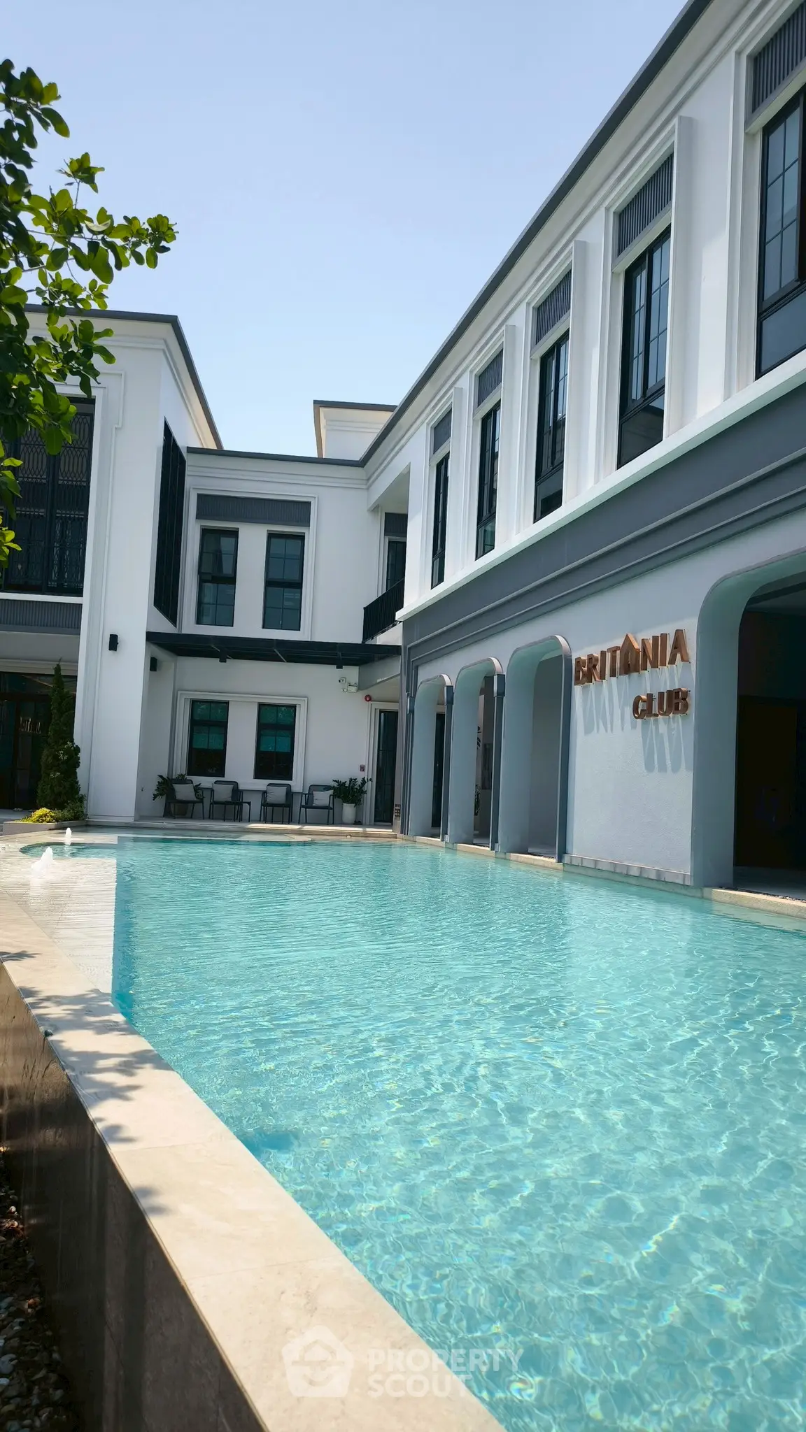 Luxurious poolside view of Britannia Club with elegant architecture and serene ambiance.