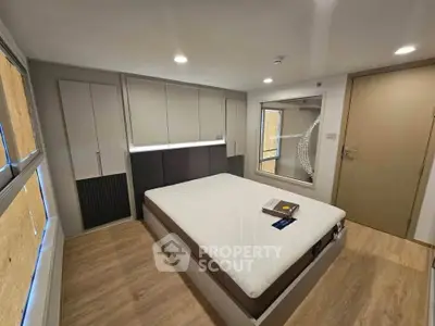 Modern bedroom with sleek design and ample storage in a contemporary apartment.