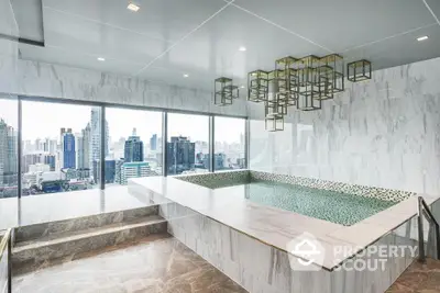 Luxurious high-rise bathroom with marble finishes and panoramic city views, featuring a large bathtub and modern lighting fixtures.