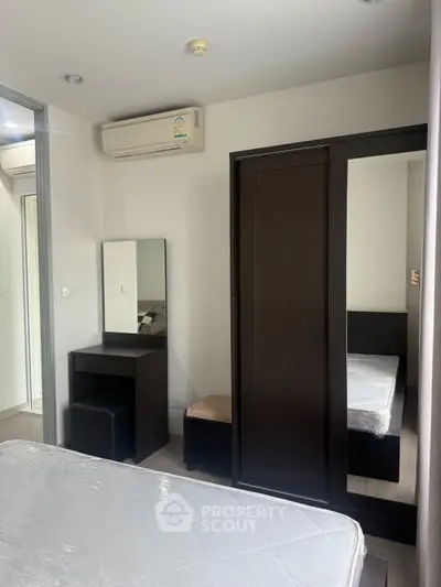 Modern bedroom with sleek furniture and air conditioning unit