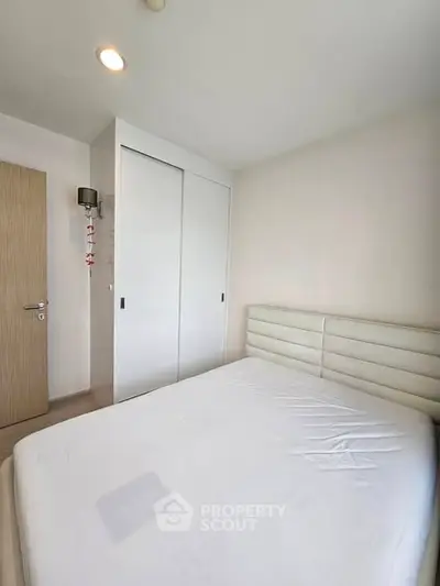 Bright and cozy bedroom with modern design and ample storage space.