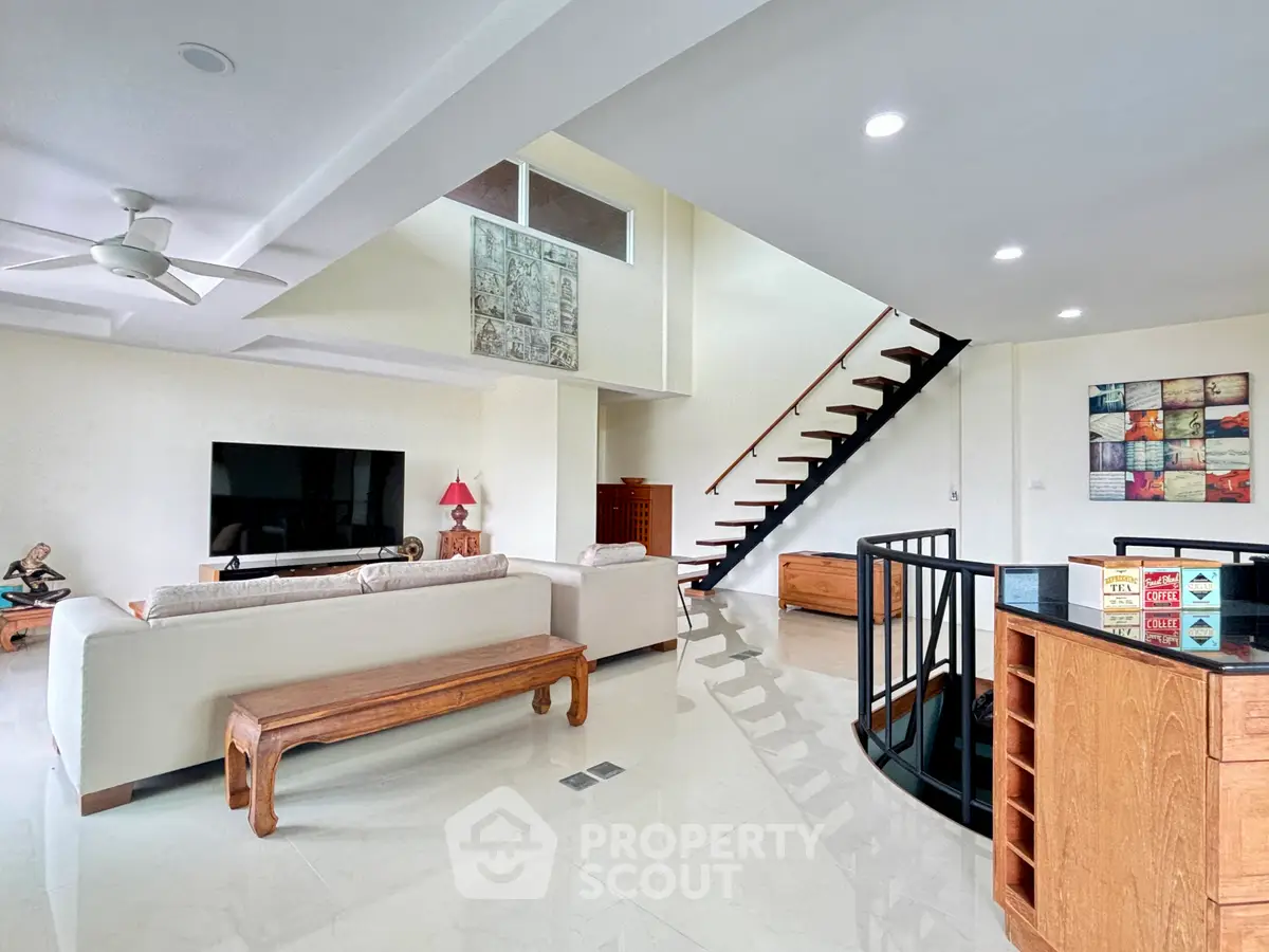 Spacious modern living room with elegant staircase and stylish decor