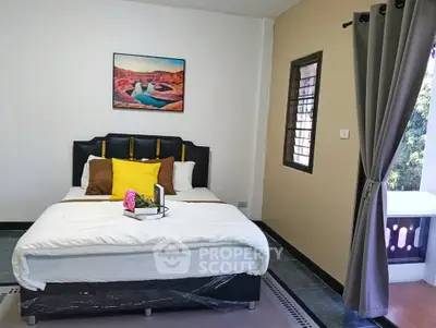 Cozy bedroom with stylish decor and natural light, perfect for relaxation.
