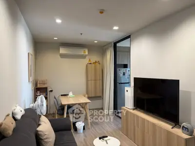 Modern living room with sleek furniture and open kitchen layout