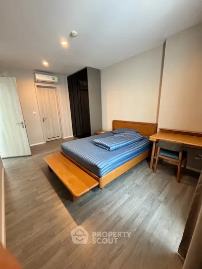 Spacious bedroom with modern wooden furniture and sleek flooring