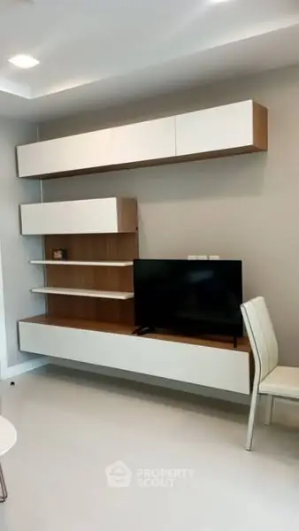 Modern living room with sleek TV unit and stylish chair