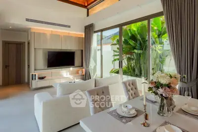 Luxurious living room with elegant decor and garden view, featuring modern furniture and large windows.