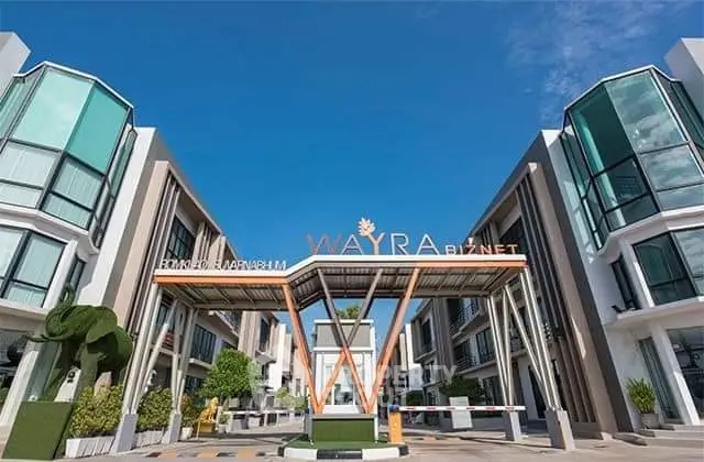 Modern commercial building exterior with unique architectural design and clear blue sky.