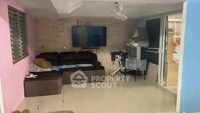 Spacious living room with modern TV setup and cozy sectional sofa.