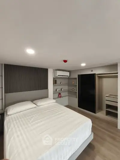 Modern bedroom with sleek design, built-in storage, and ambient lighting for a cozy living experience.