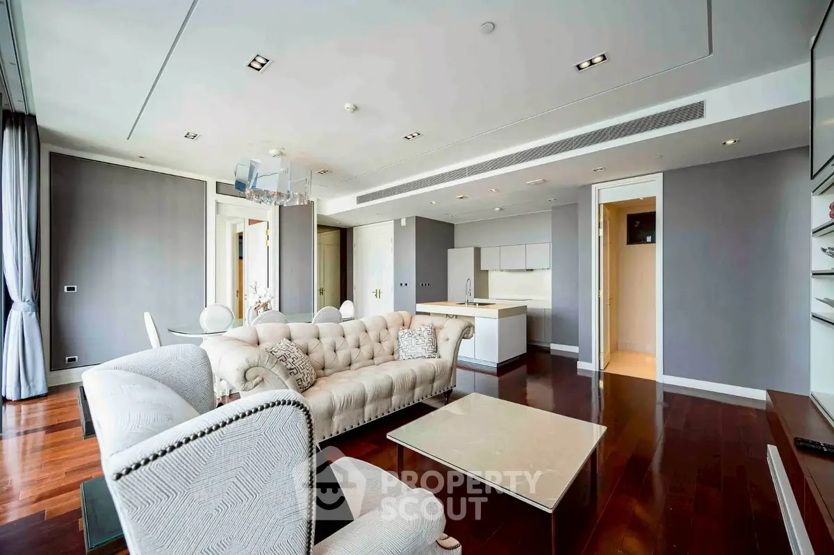 Luxurious modern living room with elegant furniture and open kitchen layout.