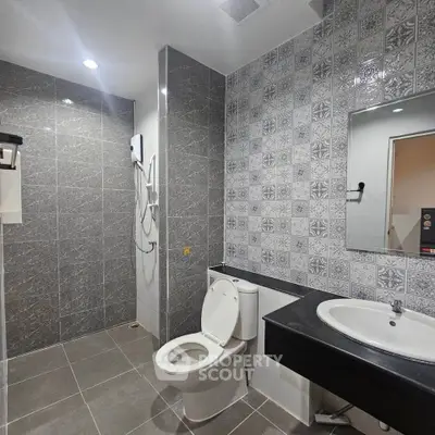 Modern bathroom with stylish tiles and sleek fixtures in a contemporary real estate property.