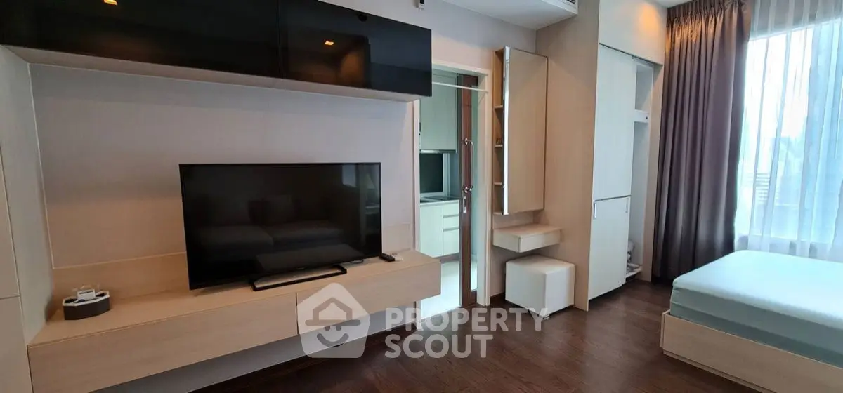 Modern bedroom with sleek TV setup and stylish furniture