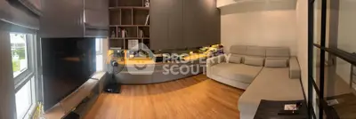 Modern living room with sleek furniture and large TV, perfect for relaxation and entertainment.