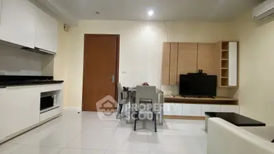 Modern living room with sleek furniture and integrated kitchen appliances