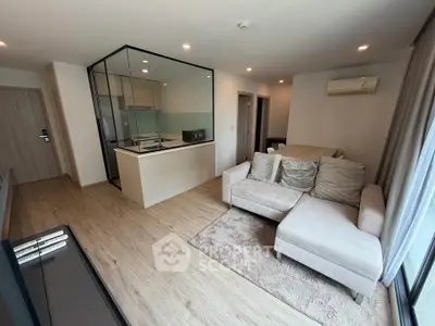 Modern living room with open kitchen and cozy sofa in stylish apartment