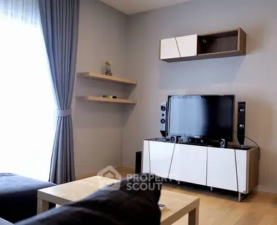 Modern minimalist living room with sleek entertainment unit, comfortable seating, and warm wooden flooring, perfect for cozy family gatherings.