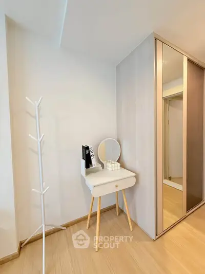 Stylish modern bedroom corner with vanity and mirrored wardrobe