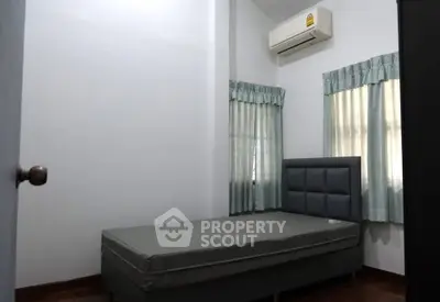 Cozy bedroom with air conditioning and natural light, perfect for restful nights.