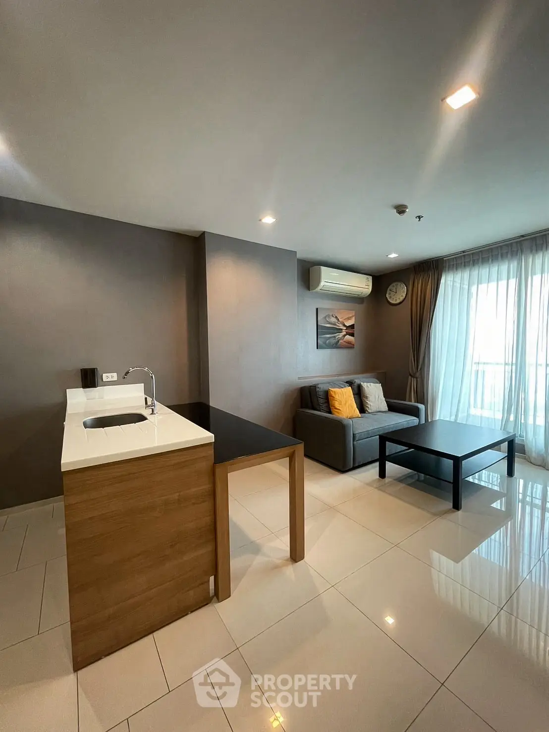 Modern living room with open kitchen and sleek design in a stylish apartment.