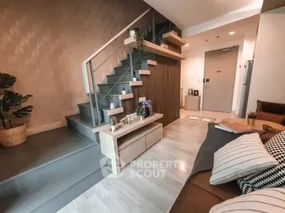 Modern living room with stylish staircase and cozy decor