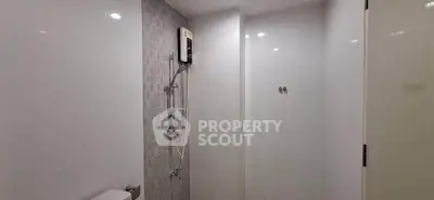 Modern bathroom with sleek shower and tiled walls
