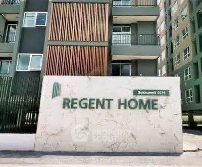 Modern apartment building exterior with Regent Home signage in urban setting.