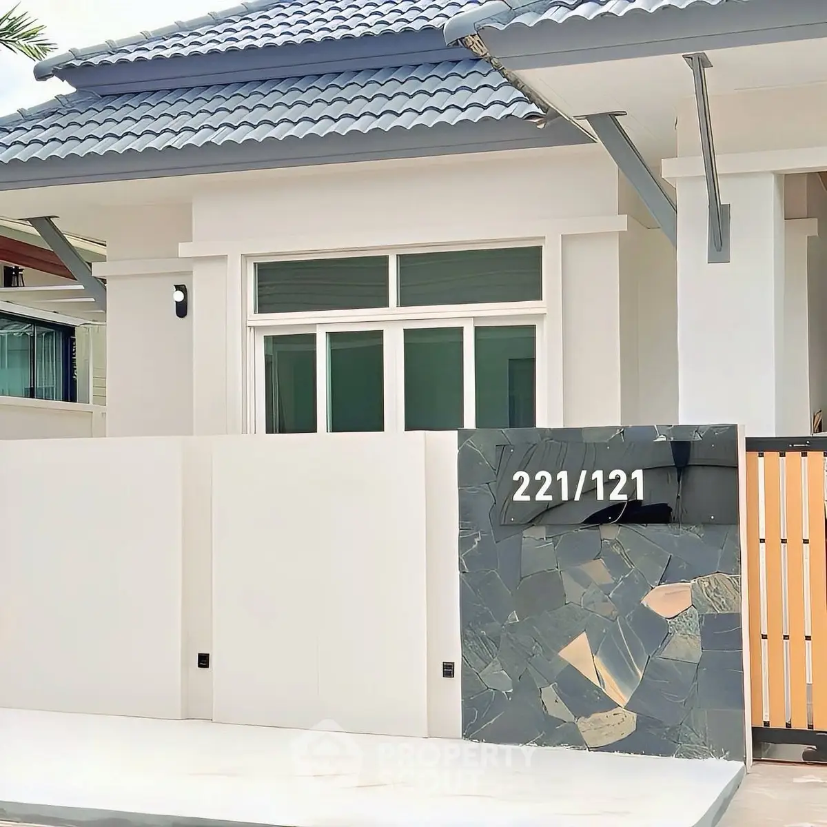 Modern house exterior with stylish facade and unique address plaque.