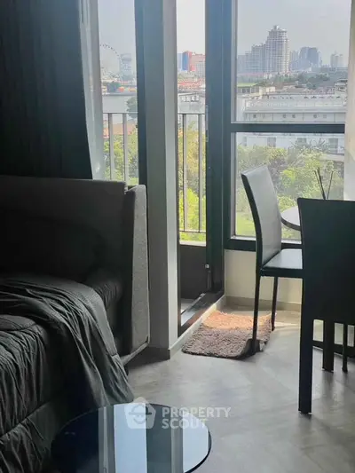 Cozy living room with city view and balcony access, perfect for urban living.
