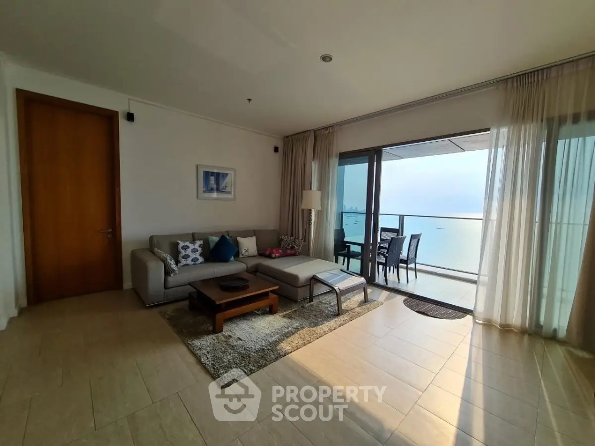 Spacious living room with ocean view and large balcony access