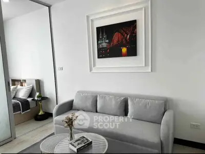 Modern living room with gray sofa and stylish decor in a contemporary apartment.