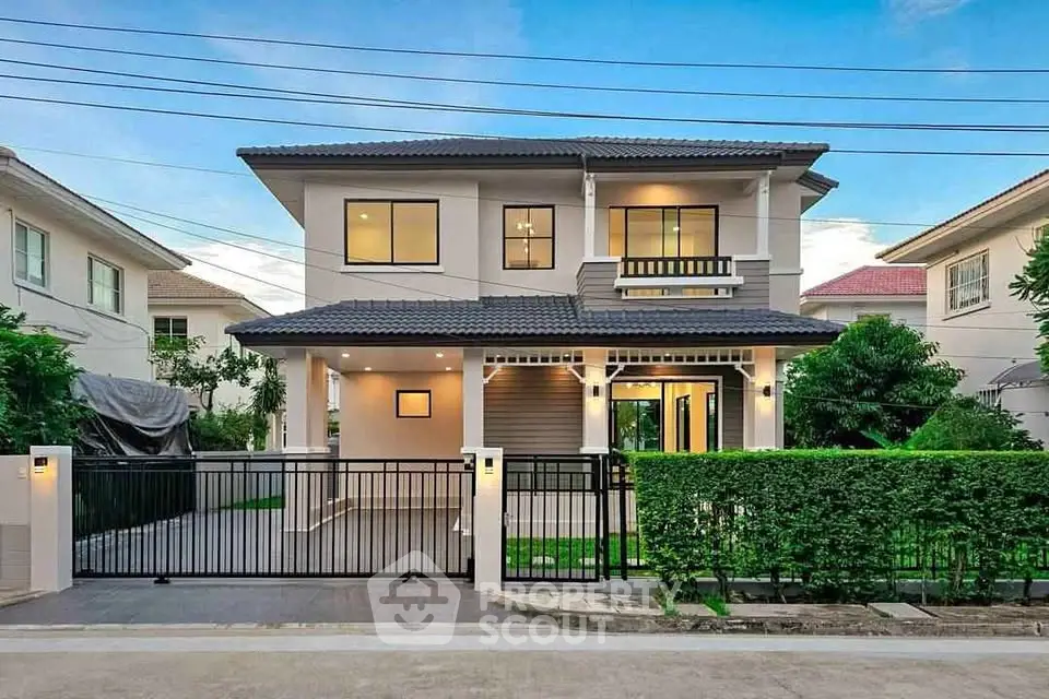 Stunning modern two-story house with lush garden and gated entrance in a serene neighborhood.