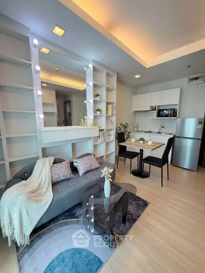 Modern living room with stylish decor and open kitchen layout, perfect for urban living.