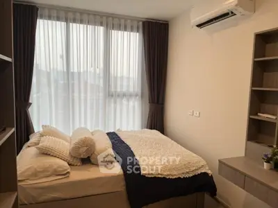 Cozy modern bedroom with large window and stylish decor