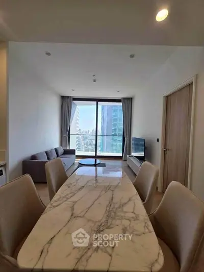 Modern living room with marble dining table and city view through large window.