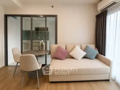 Modern living room with cozy sofa and dining area in open layout apartment.