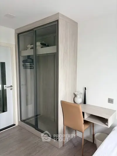 Modern bedroom with sleek wardrobe and compact study desk, perfect for urban living.