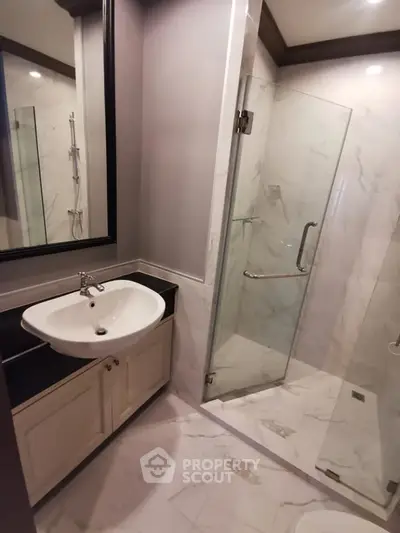 Modern bathroom with glass shower and elegant sink vanity