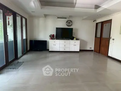 Spacious living room with modern decor and large windows for natural light.