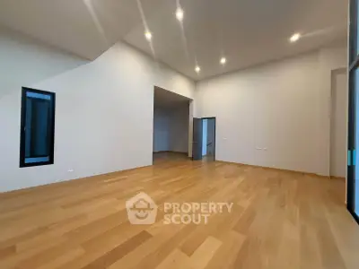 Spacious modern living room with wooden flooring and recessed lighting