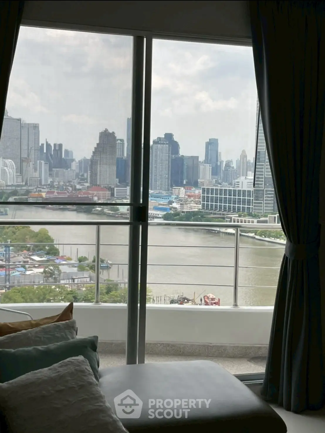 Stunning city and river view from a high-rise apartment balcony.