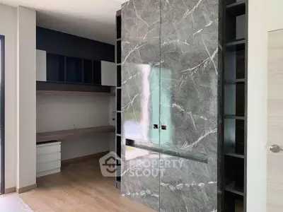 Modern study room with elegant marble accents and built-in shelving