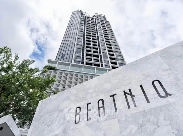 Modern high-rise building with sleek design and prominent BEATNIQ signage.