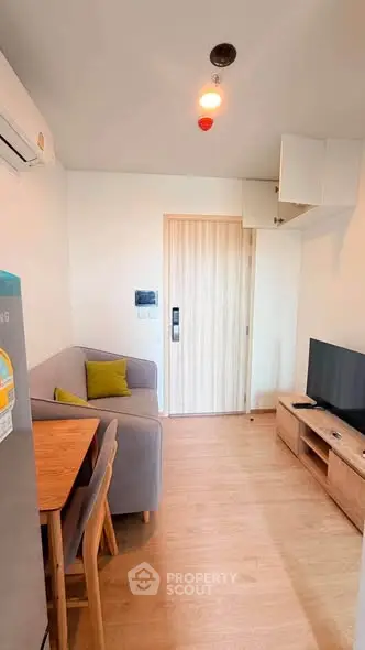 Cozy living room with modern furniture and wooden flooring, perfect for relaxation and entertainment.