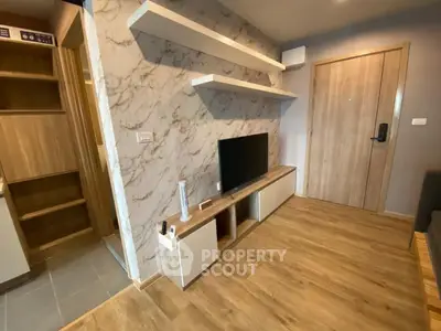 Modern living room with wood flooring and marble accent wall