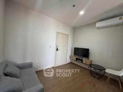 Modern living room with sleek furniture and air conditioning, perfect for comfortable living.